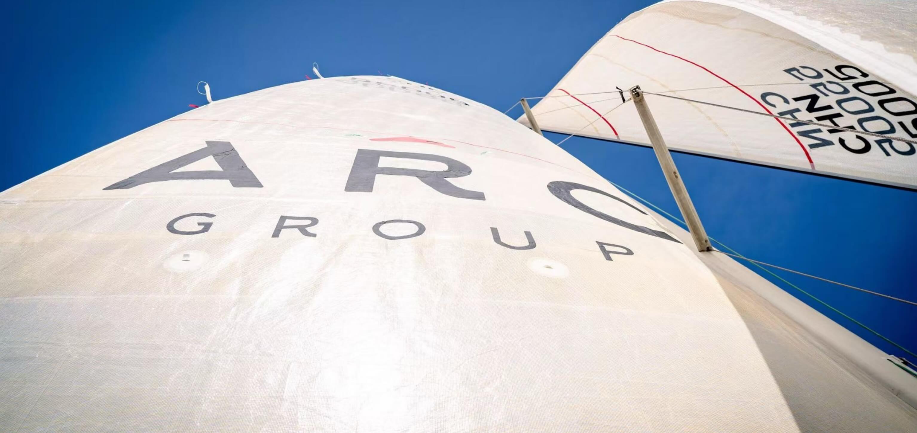 A yacht's sail branded with the ARC Group logo