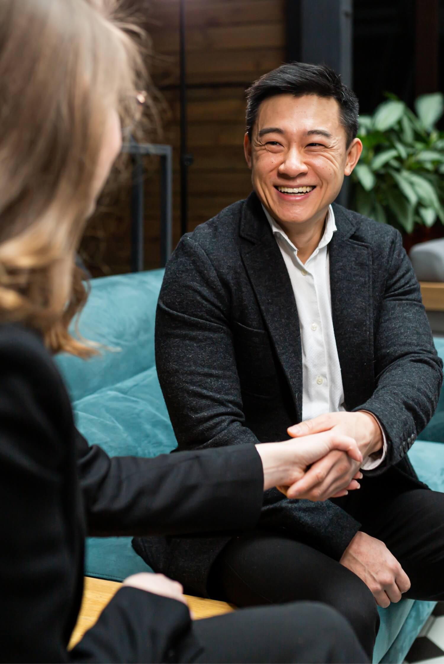 A man and woman shake hands