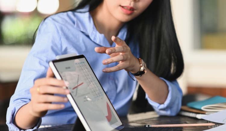 Consultant explaining data on a tablet screen